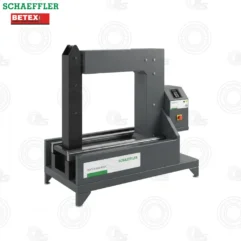 Grey industrial heating press with a vertical frame and control panel on the right, labeled HEATER1600-BASIC by Schaeffler