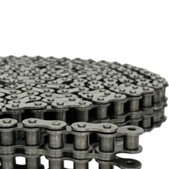 Close-up of stacked metal bicycle chain links arranged in a layered square block on a white background.